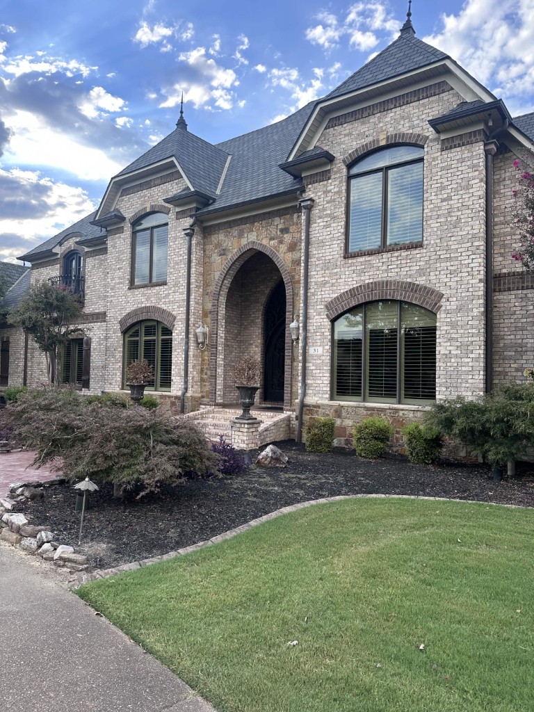 Brick home with arched windows after exterior care