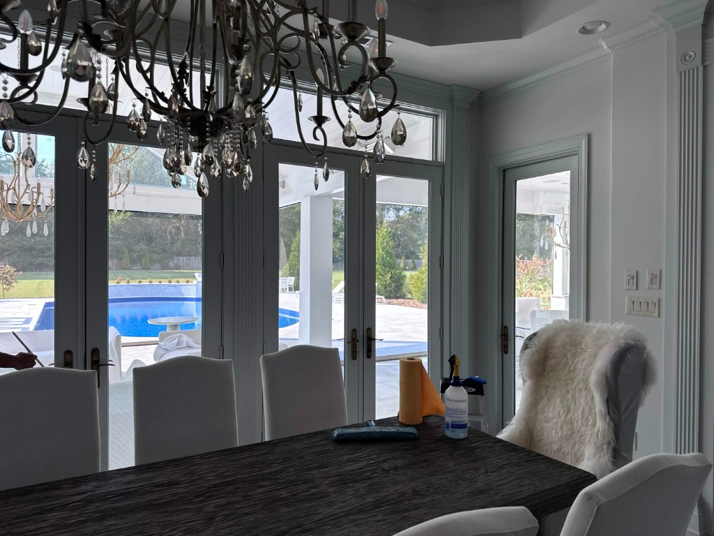 Interior french doors looking out to a pool after glass cleaning